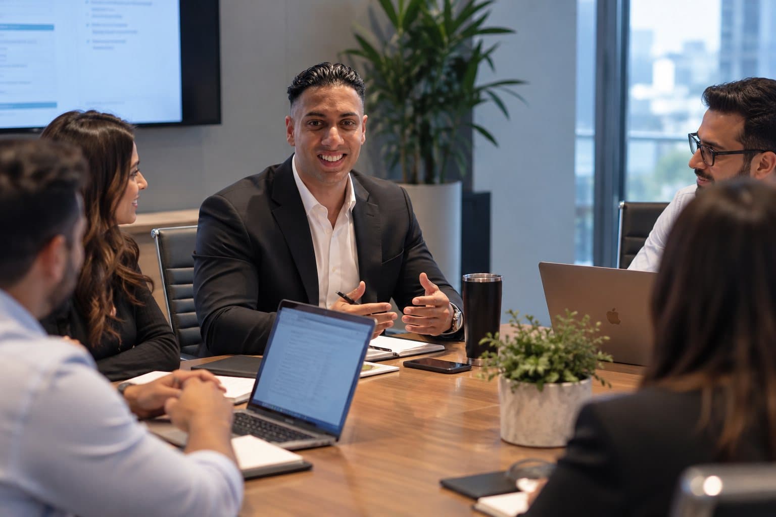 Jay leading a conversation around a meeting table